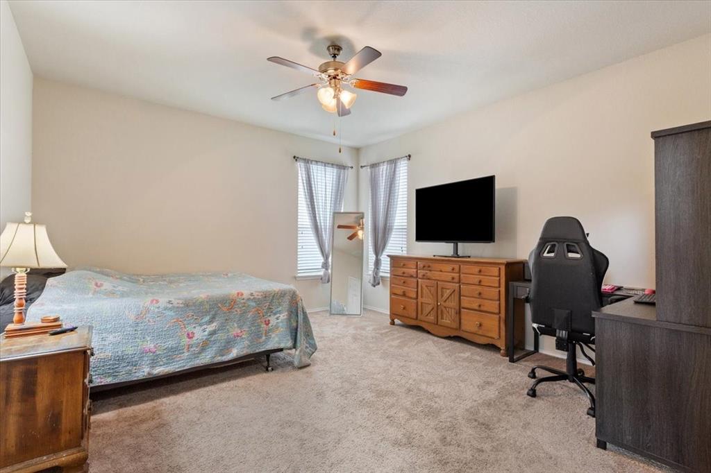 5300 Crossville Drive Waco, TX 76708 - Photo 13 of 33 a bedroom with bed tv and a chandelier