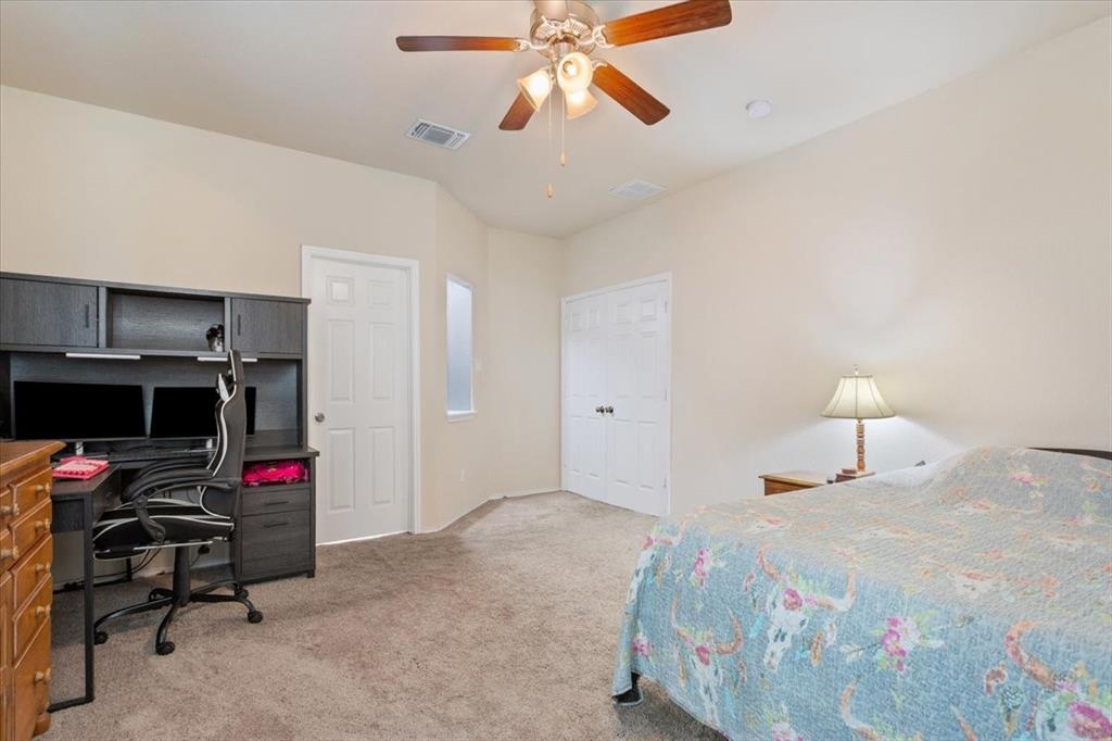 5300 Crossville Drive Waco, TX 76708 - Photo 14 of 33 a bedroom with a bed and a chandelier