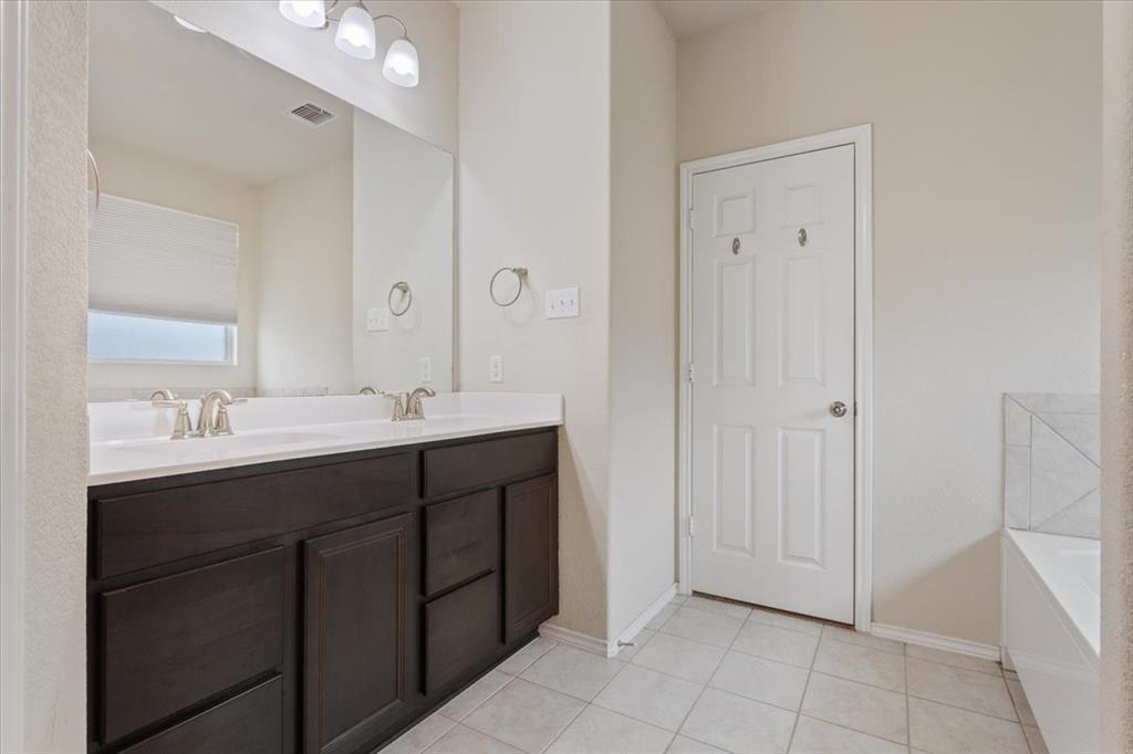 5300 Crossville Drive Waco, TX 76708 - Photo 15 of 33 a bathroom with a double vanity sink and mirror