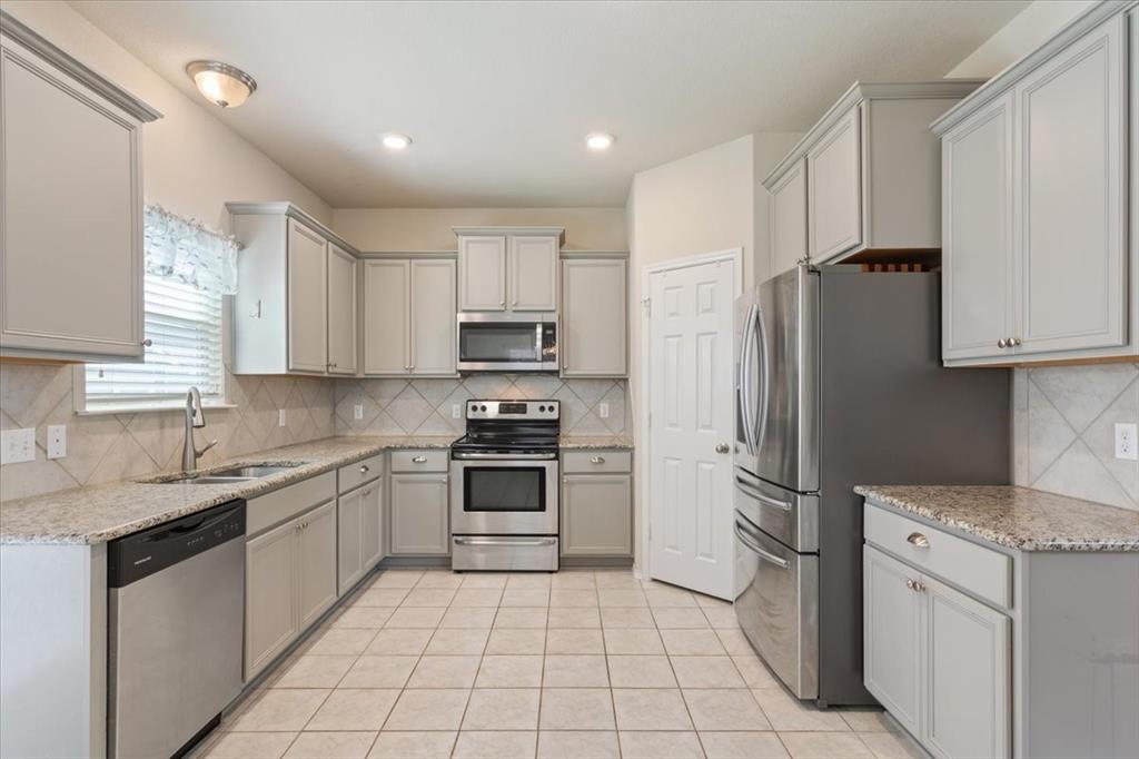5300 Crossville Drive Waco, TX 76708 - Photo 10 of 33 a kitchen with stainless steel appliances granite countertop a refrigerator sink and stove