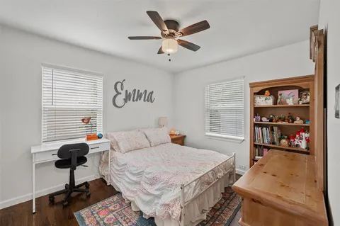 a bedroom that has a bed and a bookshelf in it
