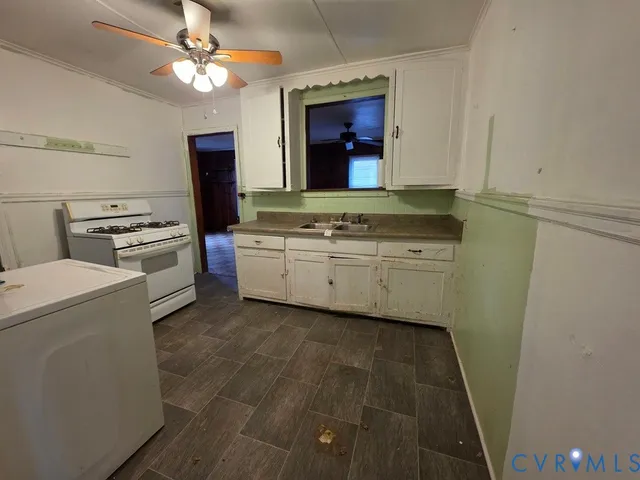 a kitchen with cabinets a washer and dryer