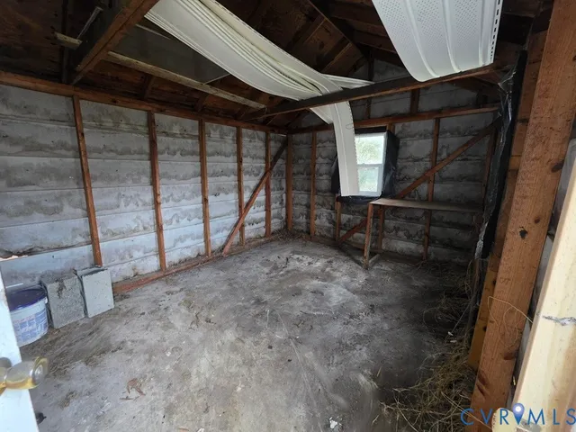 a view of empty room with wooden walls