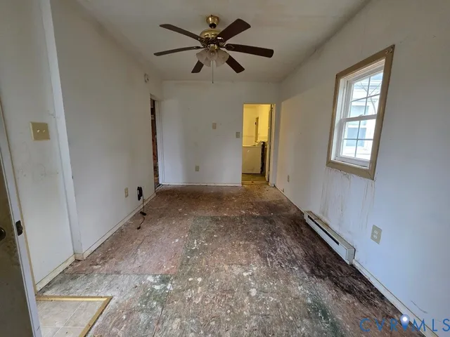 wooden floor in an empty room with a window