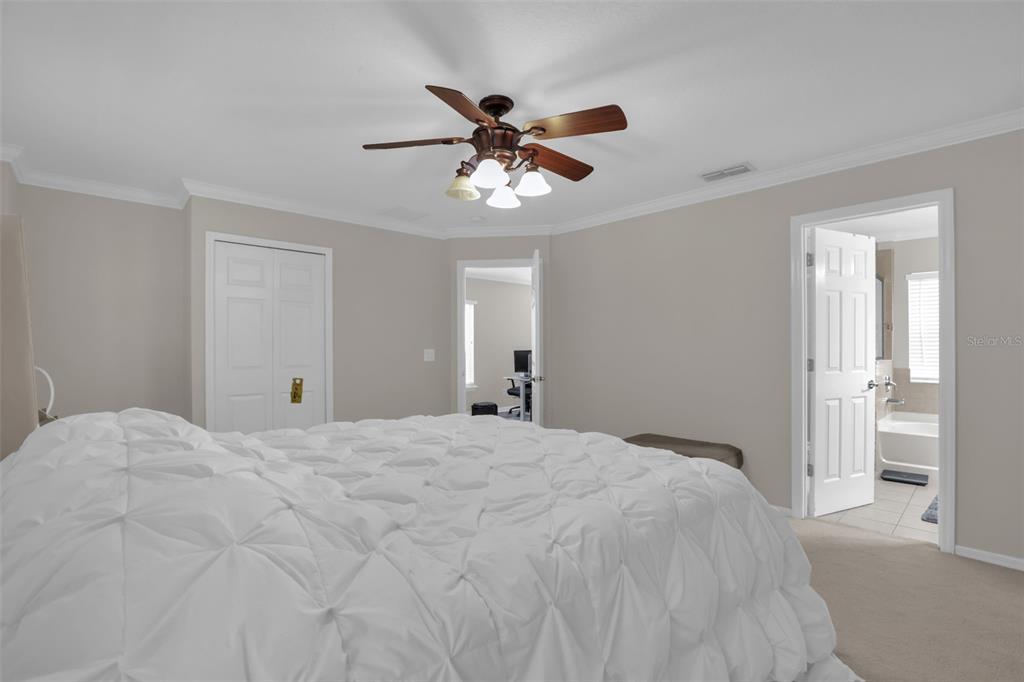 2165 Ridgewood Street Orlando, FL 32803 - Photo 18 of 37 a bedroom with a bed and a ceiling fan