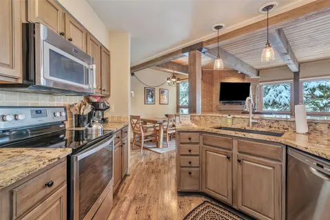 a kitchen with stainless steel appliances granite countertop a stove and a sink