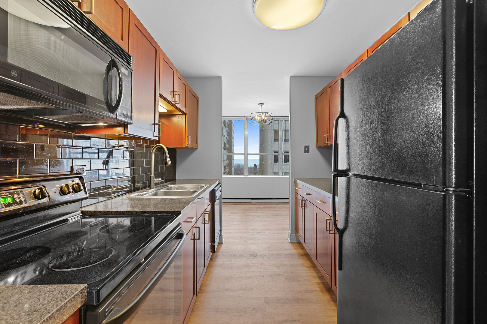 655 West Irving Park Road, Unit 701 Chicago, IL 60613 - Photo 25 of 39 a kitchen with a refrigerator and a sink