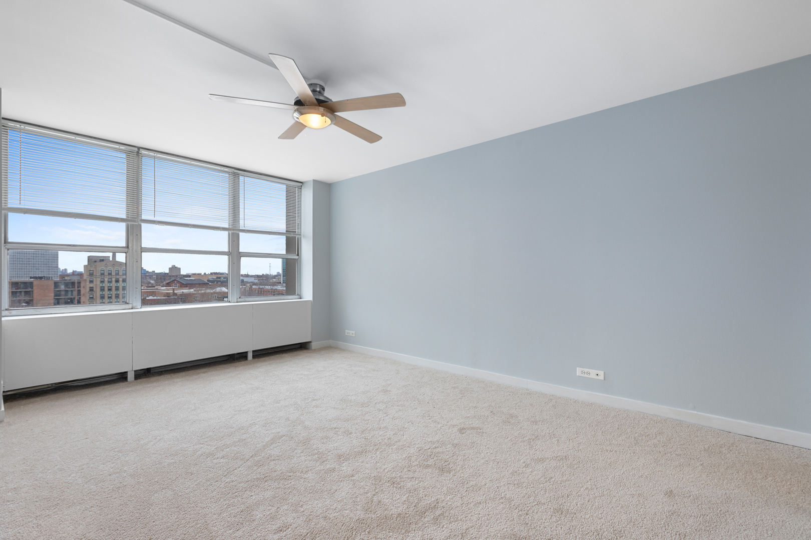 655 West Irving Park Road, Unit 701 Chicago, IL 60613 - Photo 35 of 39 an empty room with a ceiling fan and window
