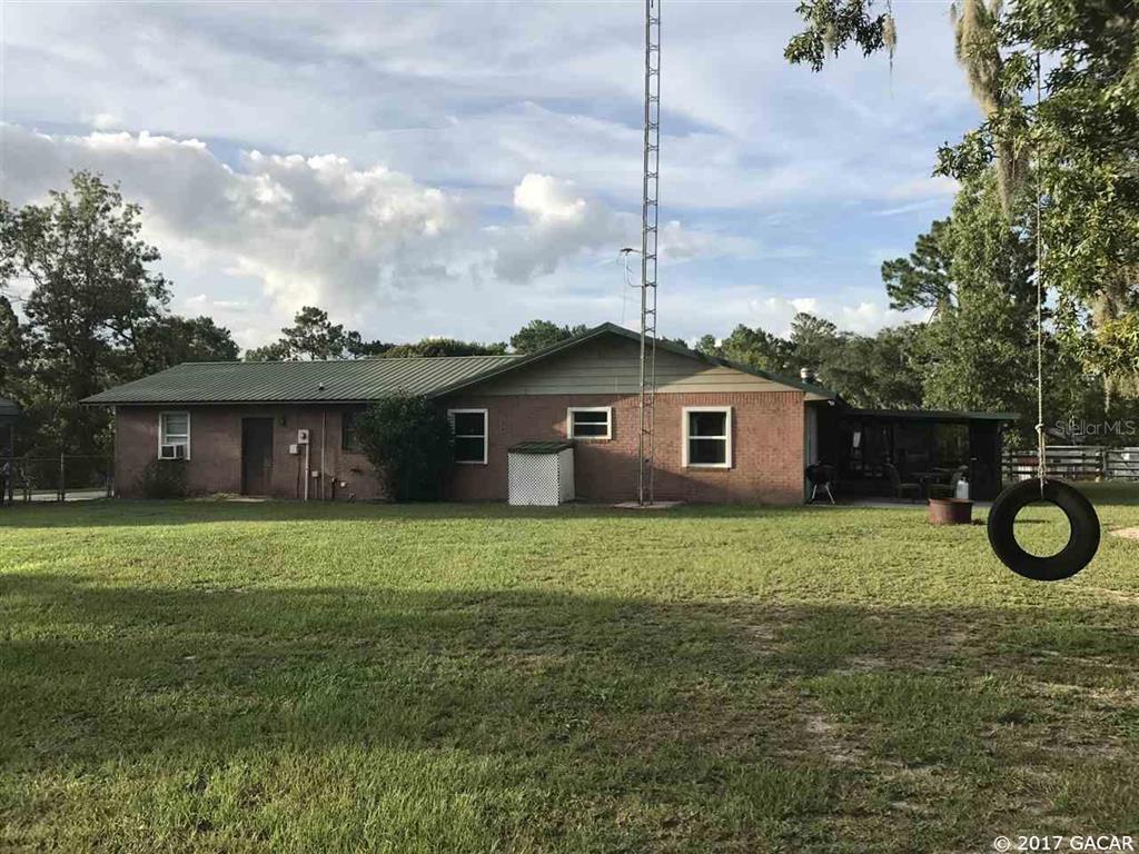 6885 Deer Springs Road Keystone Heights, FL 32656 - Photo 1 of 1 a view of a house with a backyard