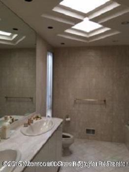 24 Clem Conover Road Deal, NJ 07723 - Photo 12 of 14 a bathroom with a sink a toilet and a mirror