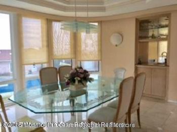 24 Clem Conover Road Deal, NJ 07723 - Photo 7 of 14 a view of a dining room with furniture wooden floor and chandelier