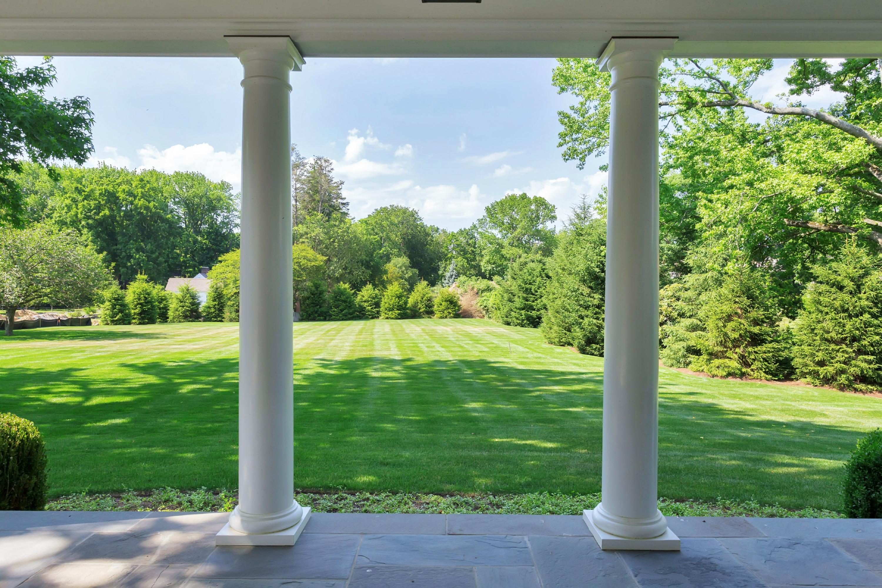 6 A Cross Road Darien, CT 06820 - Photo 22 of 24 a view of a garden with a tree in a yard