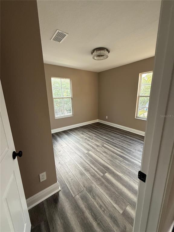 1115 Damask Street Celebration, FL 34747 - Photo 12 of 17 wooden floor in an empty room with a window