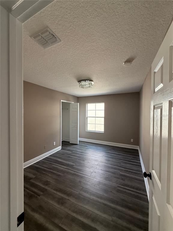 1115 Damask Street Celebration, FL 34747 - Photo 15 of 17 an empty room with wooden floor and windows