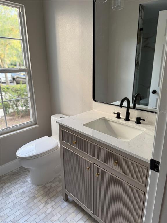1115 Damask Street Celebration, FL 34747 - Photo 5 of 17 a bathroom with a sink toilet and mirror