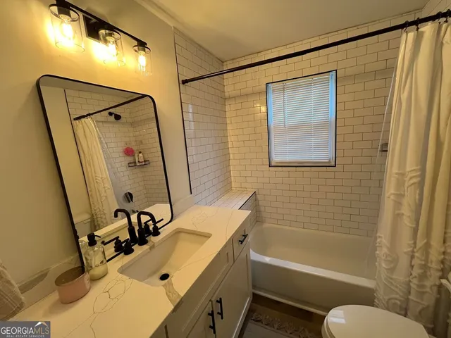 a bedroom with a bed and a flat tv screen