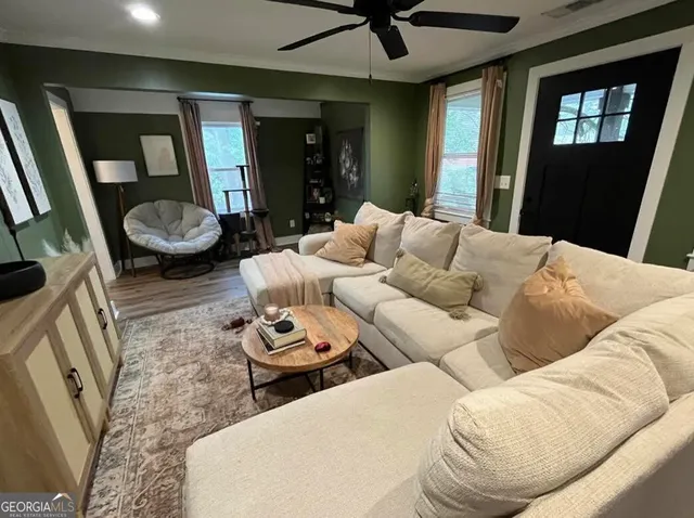 a living room with furniture and a flat screen tv