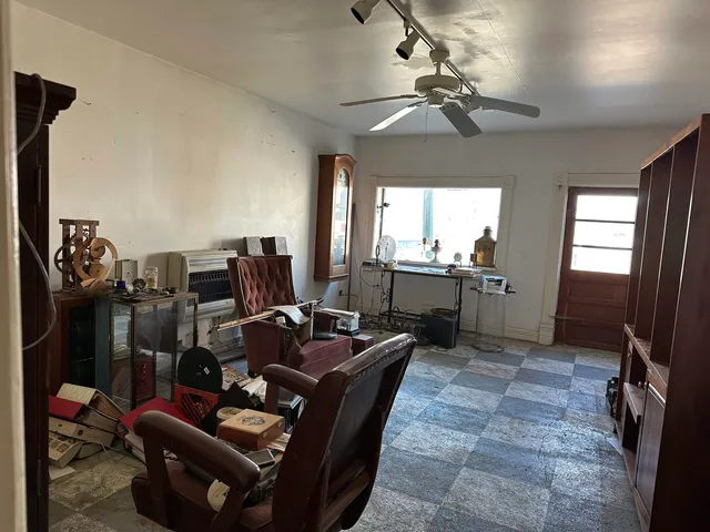 a room with furniture projector and a flat screen tv