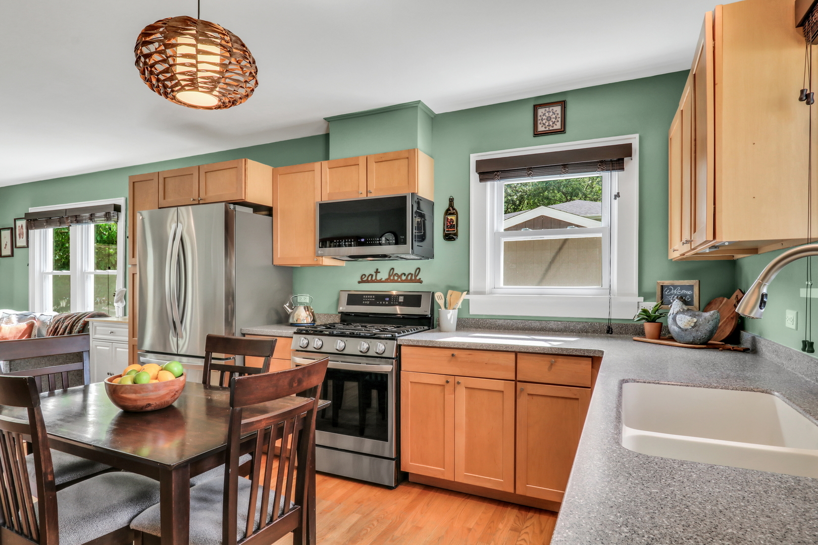 732 Rogers Road Gurnee, IL 60031 - Photo 17 of 44 a kitchen with stainless steel appliances granite countertop a stove top oven a refrigerator a sink and a dining table with garden view