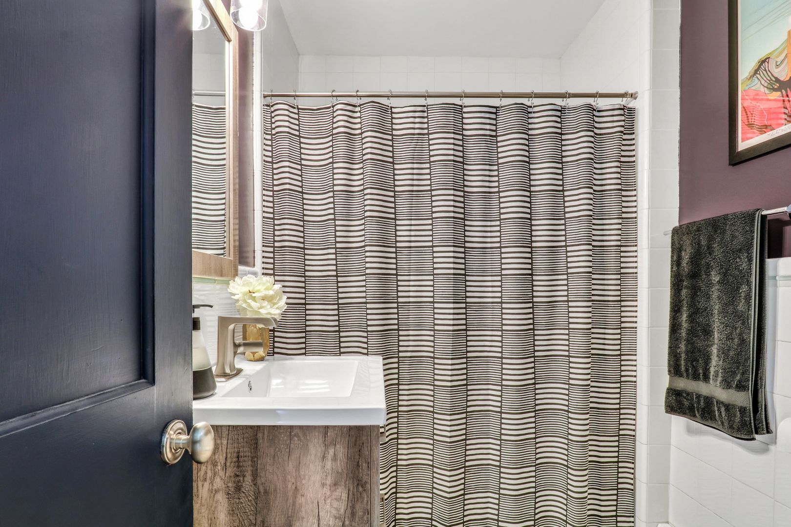 732 Rogers Road Gurnee, IL 60031 - Photo 20 of 44 a bathroom with a sink a mirror and shower curtain