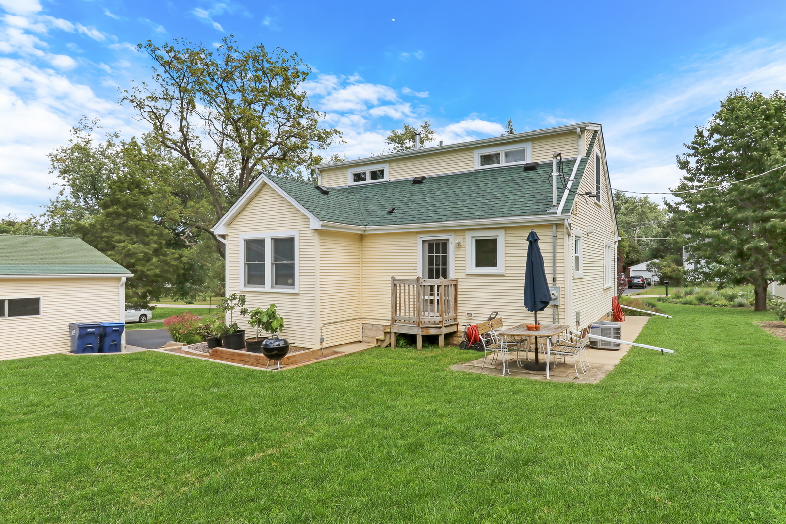 732 Rogers Road Gurnee, IL 60031 - Photo 35 of 44 a front view of house with a garden and patio