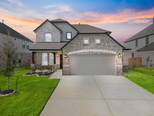 a front view of a house with a yard and garage