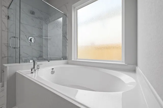 a white bath tub sitting next to a window
