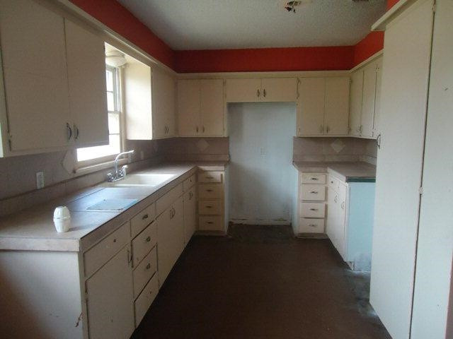2005 43rd Street Lubbock, TX 79412 - Photo 4 of 10 a kitchen with a sink and a refrigerator
