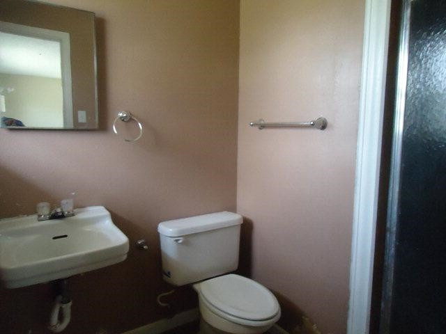 2005 43rd Street Lubbock, TX 79412 - Photo 9 of 10 a white toilet sitting next to a bathroom sink