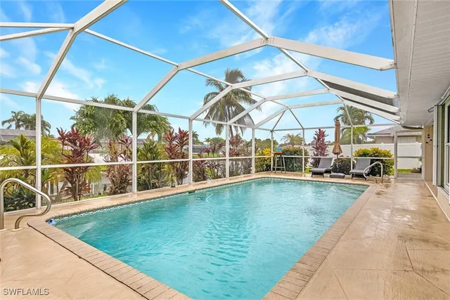 a swimming pool with outdoor seating and yard