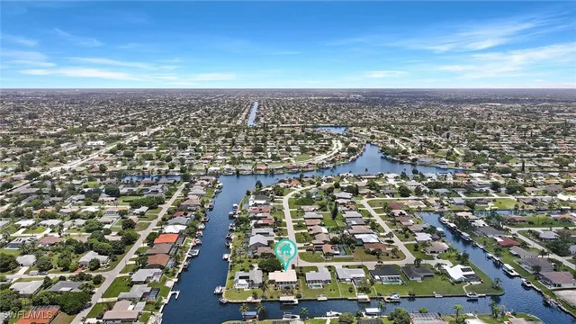 a living room with furniture a flat screen tv and a dining table