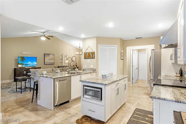 a dining room with furniture a chandelier and wooden floor