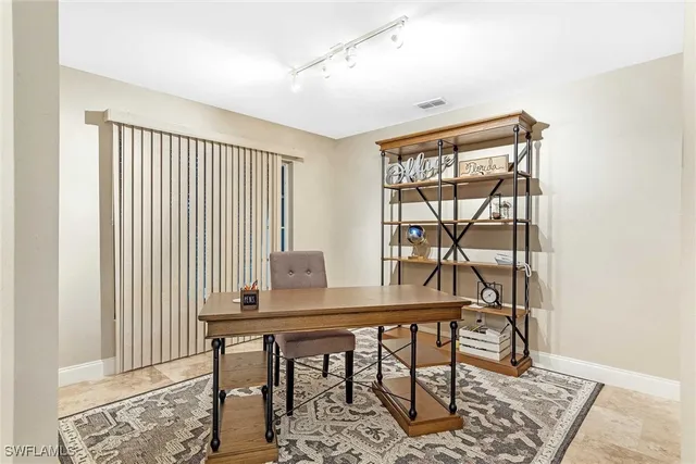 a view of a dining room with furniture and a window