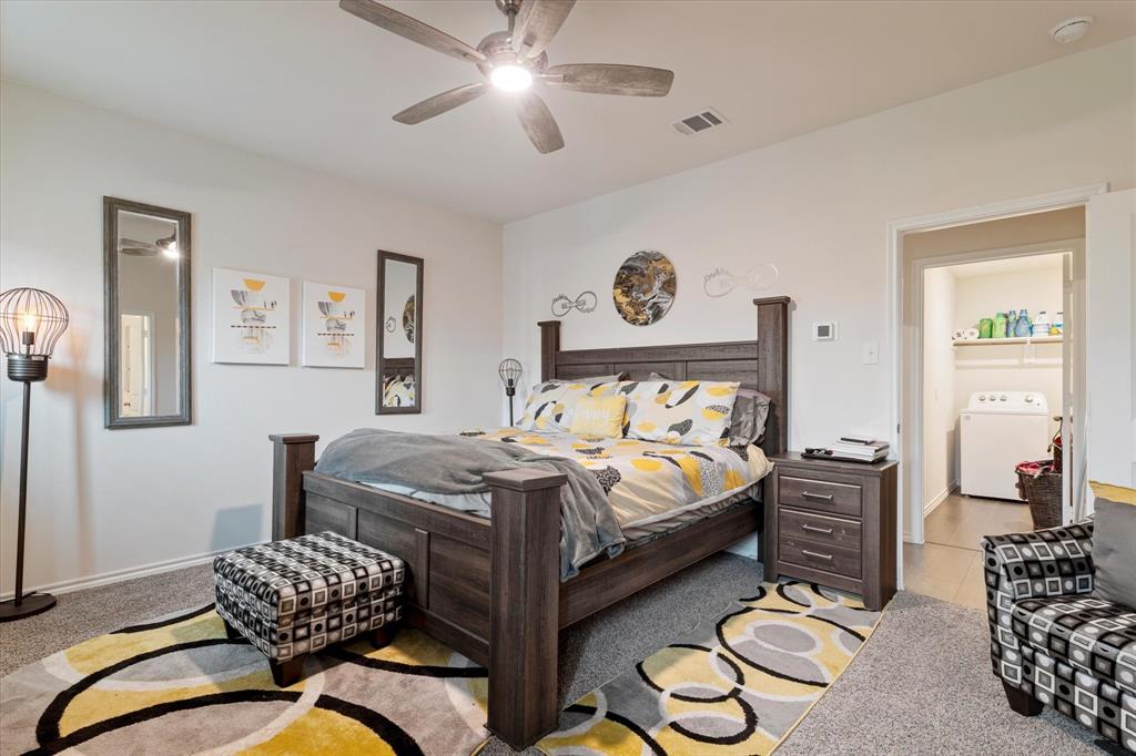 113 Clason Road Royse City, TX 75189 - Photo 13 of 25 a bedroom with a bed and a chandelier