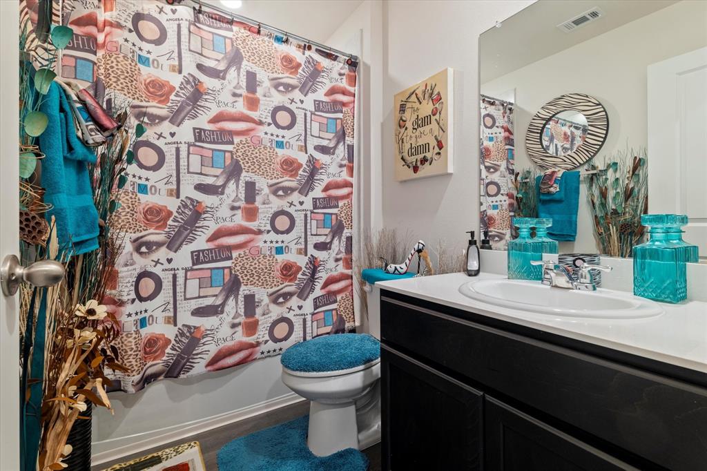 113 Clason Road Royse City, TX 75189 - Photo 17 of 25 a bathroom with a sink toilet and shower curtain