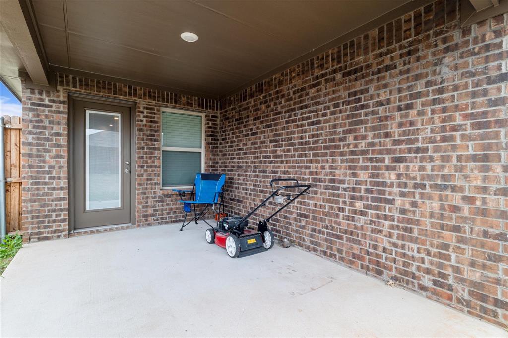 113 Clason Road Royse City, TX 75189 - Photo 23 of 25 a view of a brick wall with two chairs in the porch