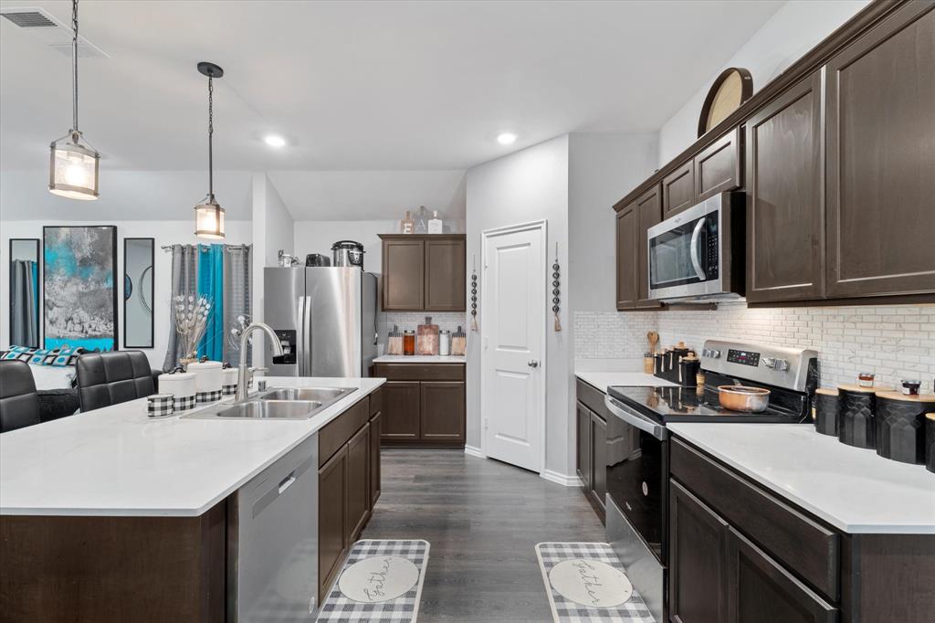 113 Clason Road Royse City, TX 75189 - Photo 8 of 25 a kitchen with stainless steel appliances a sink stove and refrigerator