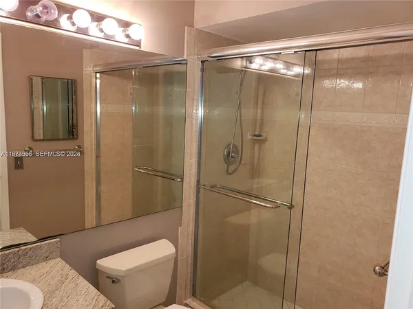 a view of walk in closet with wooden floor