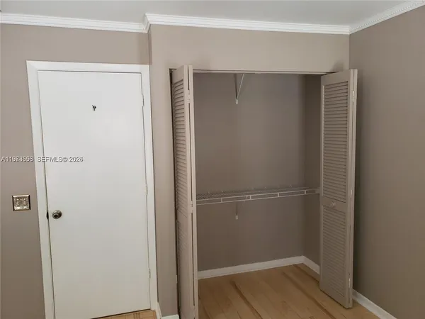 a view of a hallway with a door and stairs