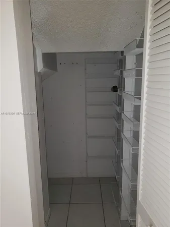 an empty room with closet and a window