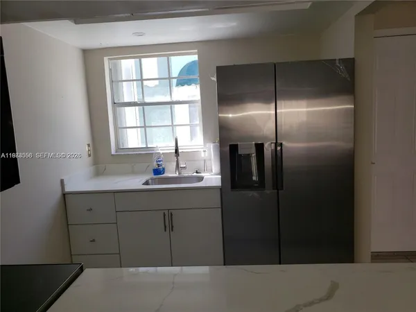 a bathroom with a shower and a sink