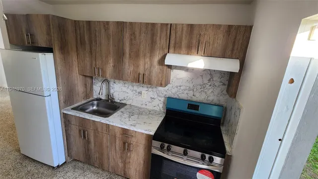 a kitchen with appliances and cabinets