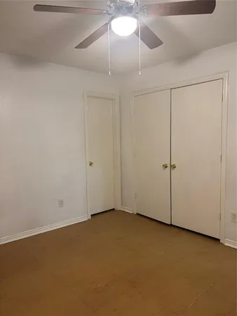 a bathroom with a granite countertop toilet a sink and mirror