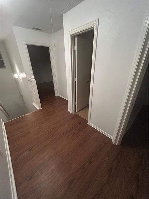 13627 Biggs Street Dallas, TX 75253 - Photo 14 of 16 an empty room with wooden floor and closet