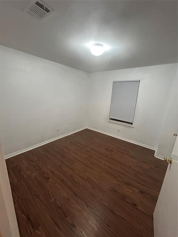 13627 Biggs Street Dallas, TX 75253 - Photo 16 of 16 an empty room with wooden floor and windows