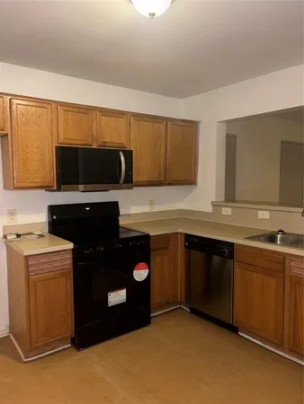 a kitchen with a sink stove and microwave