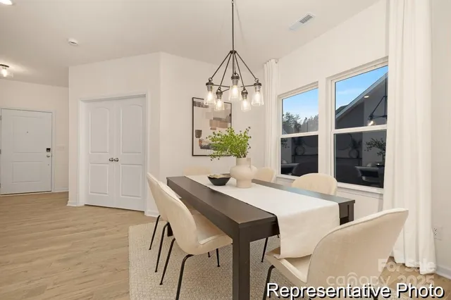 a dining room with furniture and window