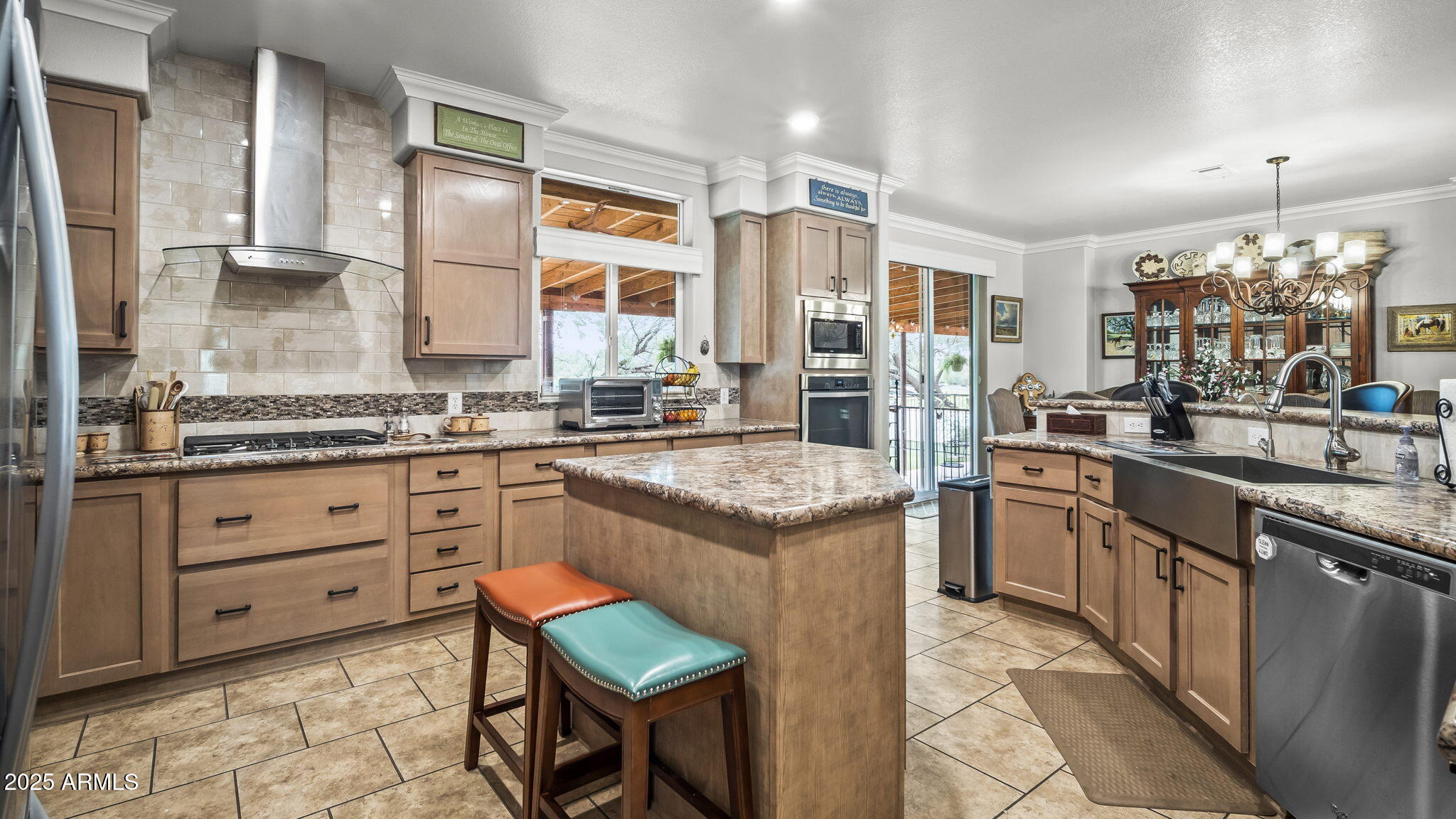 3155 West Elephant Head Road Amado, AZ 85645 - Photo 16 of 79 a kitchen with stainless steel appliances granite countertop a stove a sink and a refrigerator