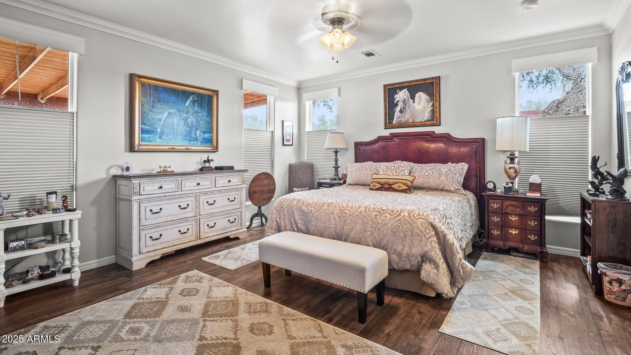 3155 West Elephant Head Road Amado, AZ 85645 - Photo 19 of 79 a bedroom with a bed and wooden floor