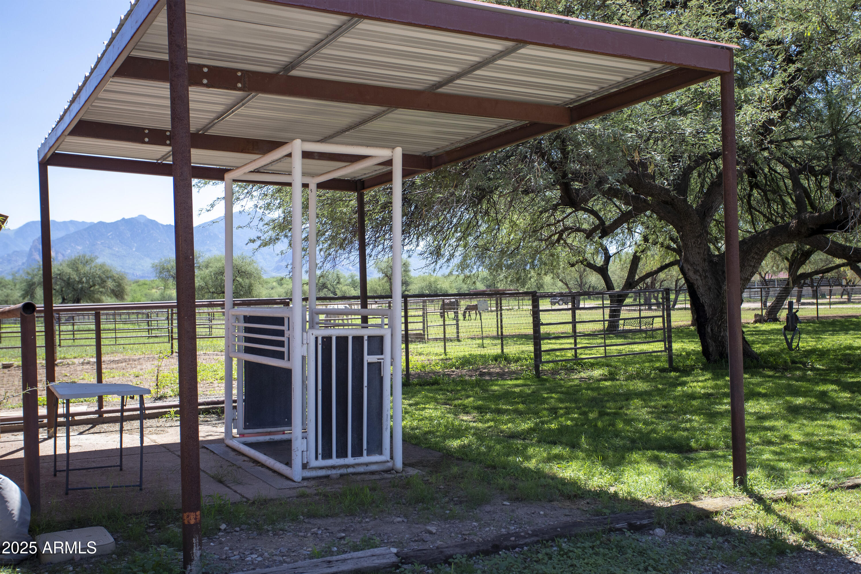 3155 West Elephant Head Road Amado, AZ 85645 - Photo 65 of 79 a view of a backyard with table and chairs under an umbrella